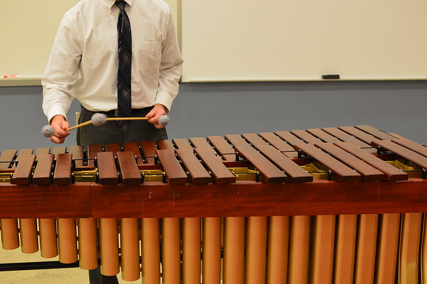 Musician playing marimba in classroom setting