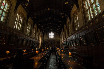 Interior of historic Oxford dining hall with stained glass windows