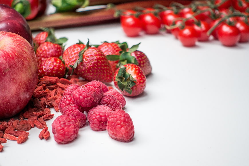 Fresh Raspberries, Strawberries, and Apples on White Background
