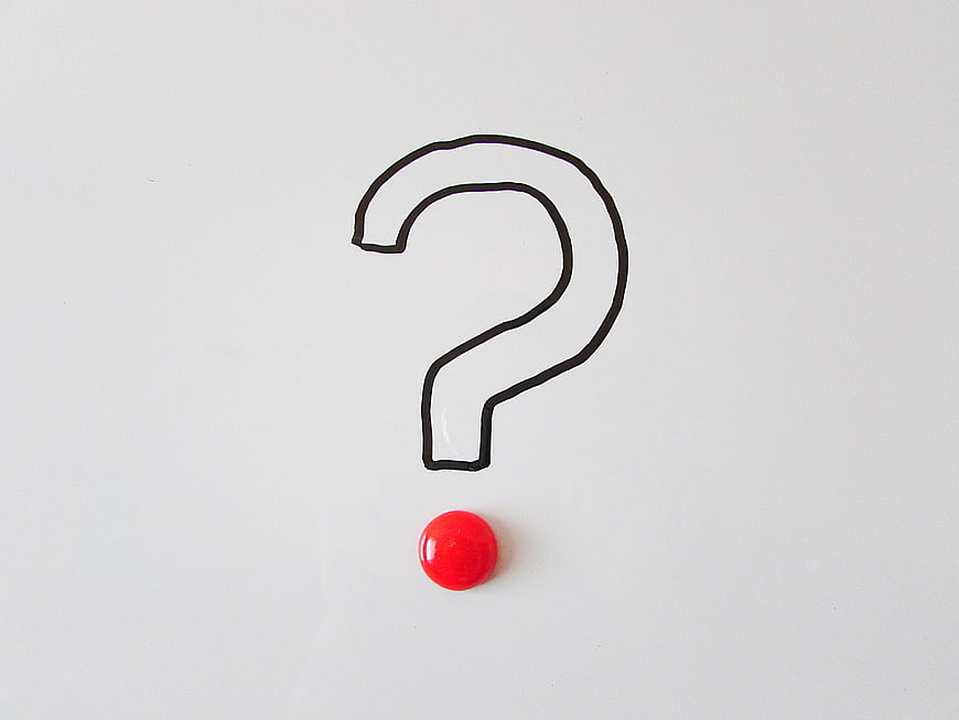 Hand-drawn question mark with red dot on white background