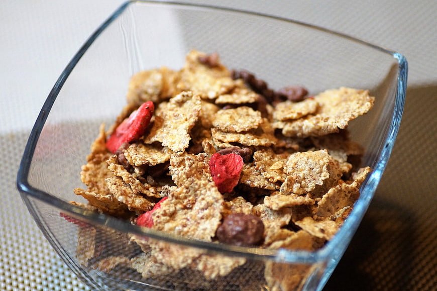 Close-up of crunchy cereal with dried fruit in a glass bowl