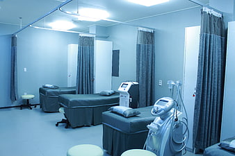 Modern medical treatment room with equipment and beds