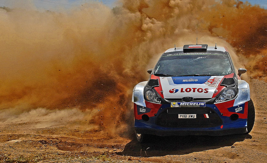 Ford Fiesta Rally Car Kicking Up Dust on Dirt Track