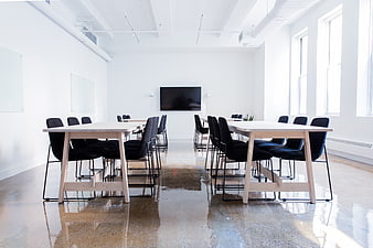 Modern minimalist white conference room with wooden tables