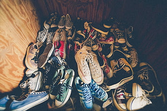 Collection of vintage sneakers and canvas shoes on wood