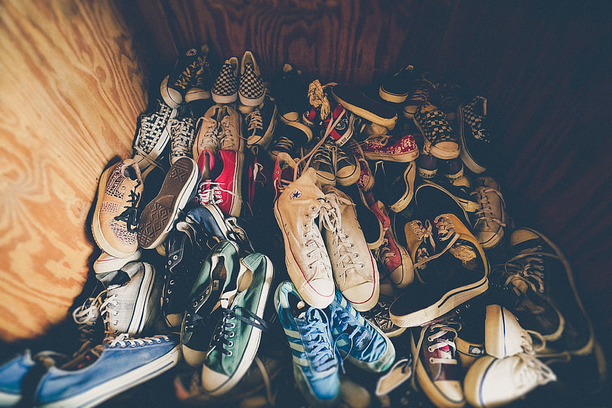 Collection of vintage sneakers and canvas shoes on wood