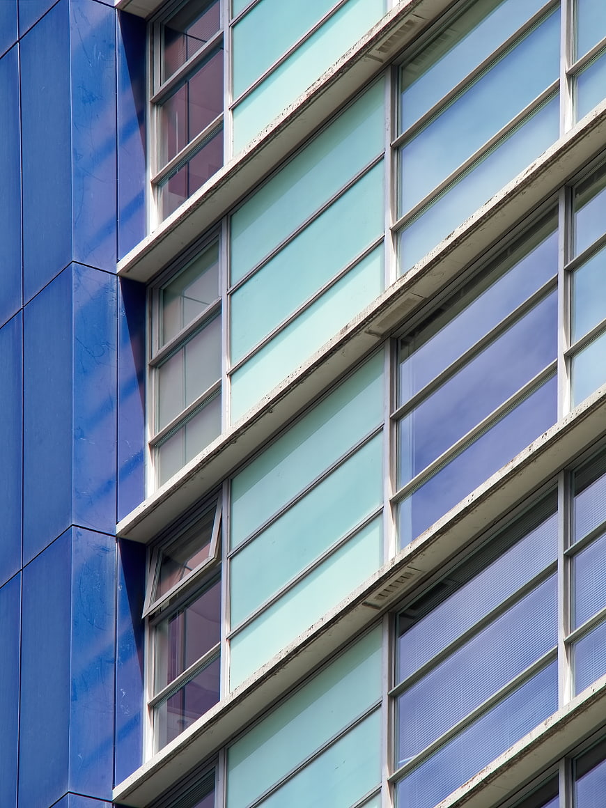 Modern Blue and Teal Office Building Facade with Windows