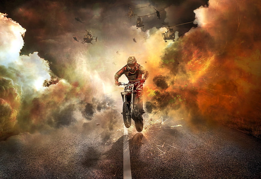 Motocross Rider Jumping Amidst Explosions and Helicopters