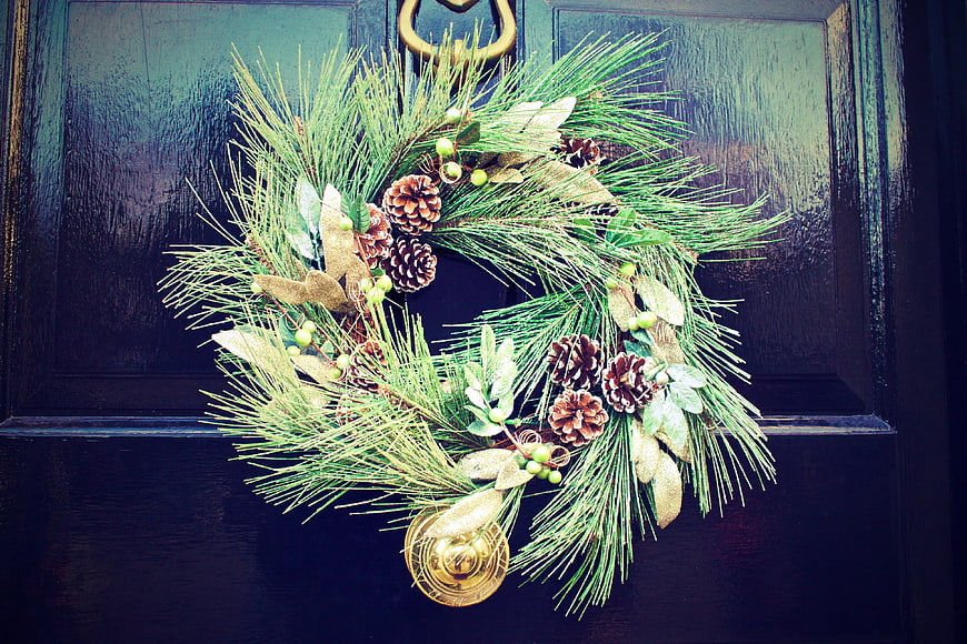 Christmas Wreath with Pine and Pinecones on Dark Door