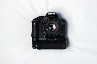 Black Canon DSLR Camera with Vertical Grip on White Background