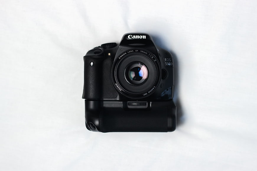 Black Canon DSLR Camera with Vertical Grip on White Background