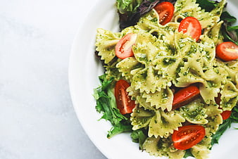 Pasta Salad with Pesto and Cherry Tomatoes on White Plate