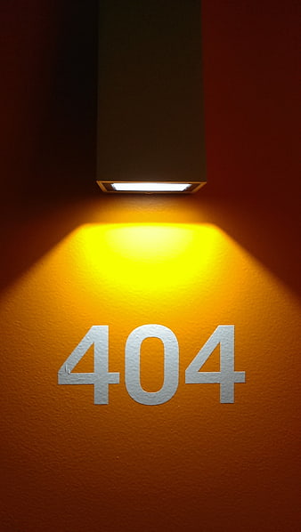 Illuminated 404 Room Number On Textured Orange Wall