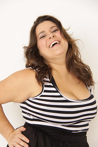 Plus Size Woman Laughing Joyfully in Striped Top