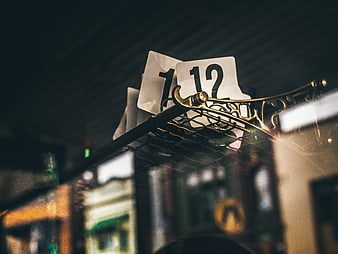 Close-up of table number 12 on ornate metal stand