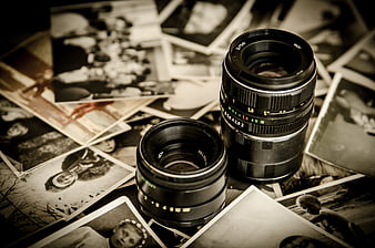 Vintage Camera Lenses on Scattered Old Black and White Photographs