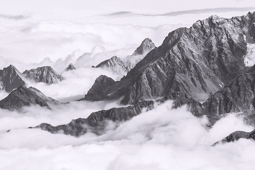 Dramatic Black and White Mountain Peaks Above Clouds