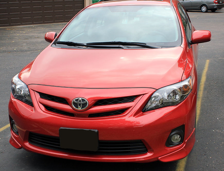 Front view of a red Toyota Corolla parked in a lot