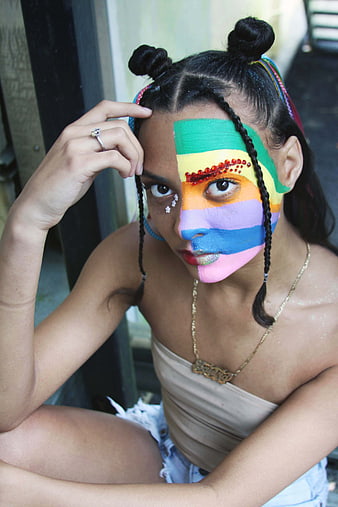 Woman with Rainbow Pride Face Paint and Braided Hair