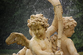 Classical cherub fountain statue with water spray