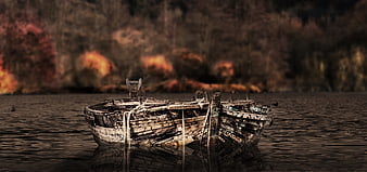 Weathered wooden boat floating on calm lake water