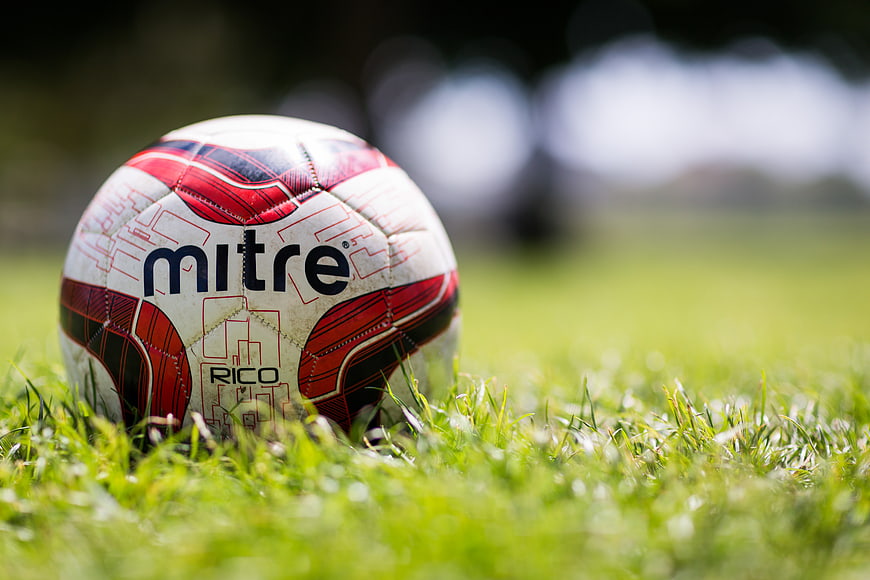 Close-up of soccer ball on green grass field