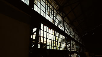 Dark Interior of Abandoned Industrial Building with Large Windows
