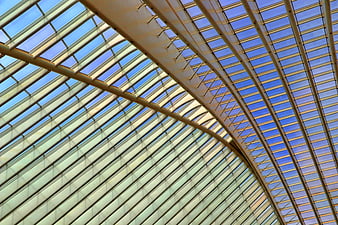 Modern Glass Roof with Steel Frames and Blue Sky
