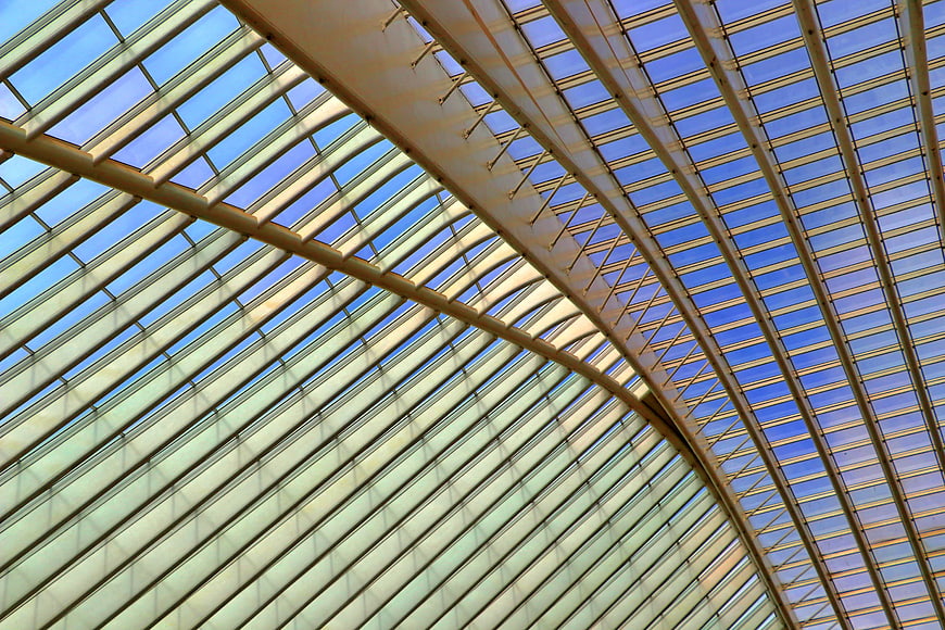 Modern Glass Roof with Steel Frames and Blue Sky