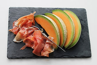 Prosciutto and Melon Slices on Slate Board