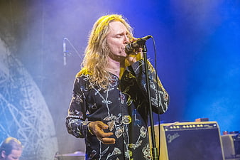 Male singer performing live on stage with microphone