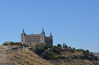 Toledo Cathedral on Hilltop Against Blue Sky