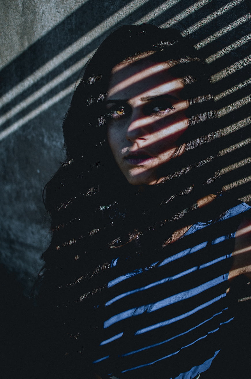 Woman's face with dramatic striped shadows