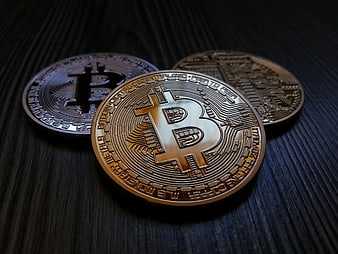 Physical Bitcoin Coins on Dark Wood Surface