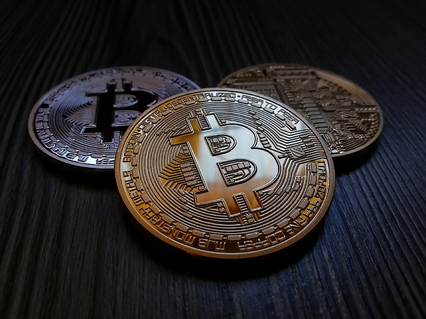 Physical Bitcoin Coins on Dark Wood Surface