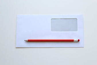 Red Pencil on White Window Envelope Flat Lay