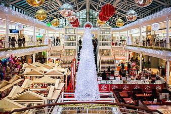 Festive Shopping Mall Interior with Giant White Christmas Tree