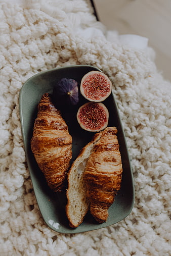 Croissants and fresh figs on a ceramic plate