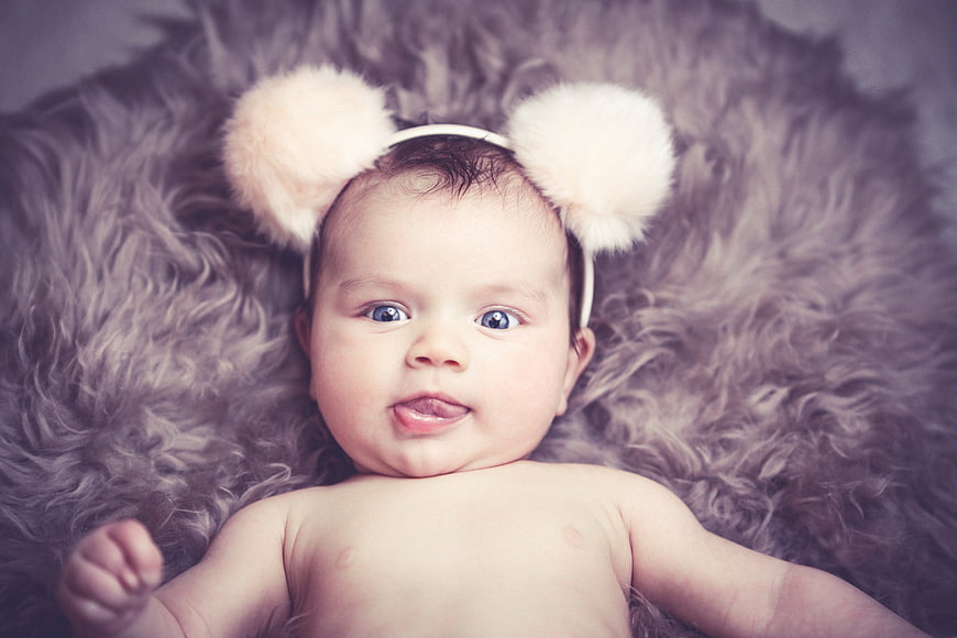 Cute Baby Girl Wearing Fluffy Bear Ear Headband On Fur
