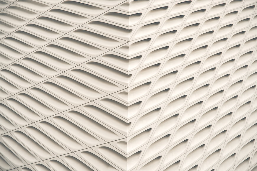 White geometric architectural facade with repeating pattern