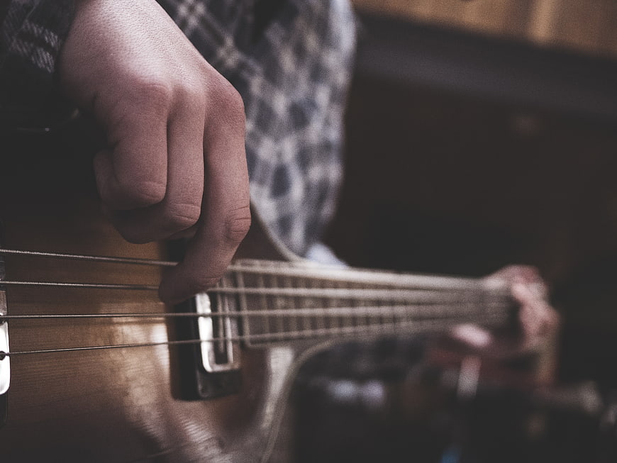 Close-up of hands playing an acoustic guitar