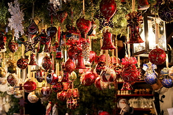 Traditional Christmas ornaments hanging at a festive market stall