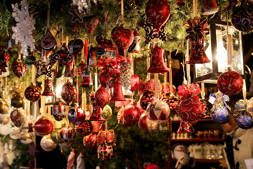 Traditional Christmas ornaments hanging at a festive market stall
