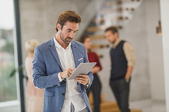 Professional man using tablet in modern office