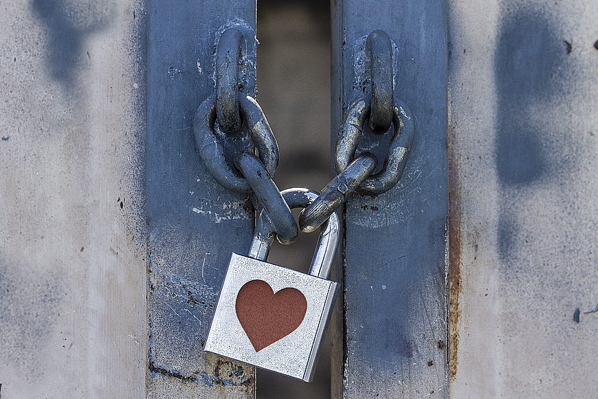 Heart Padlock Securing Weathered Blue Metal Gate