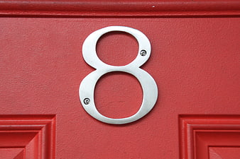 Silver Number 8 Plaque on Red Door