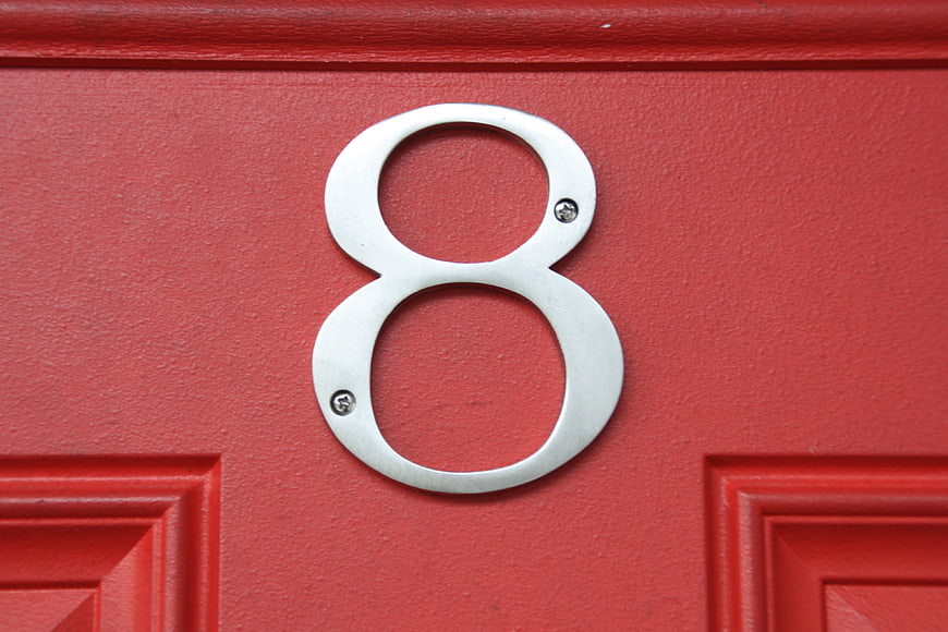 Silver Number 8 Plaque on Red Door