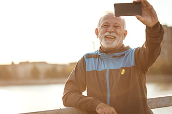 Happy Senior Man Taking Selfie Outdoors in Sportswear