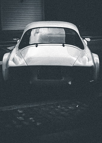 Rear view of vintage classic car in grainy black and white