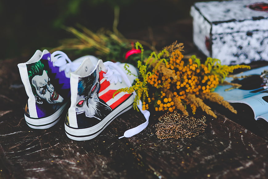 Custom painted high-top sneakers with Joker and Bane designs